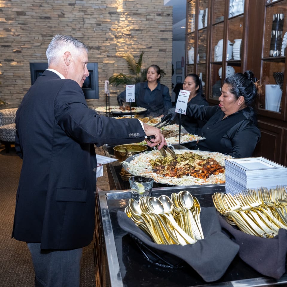 Guest serving appetizers at a catered event