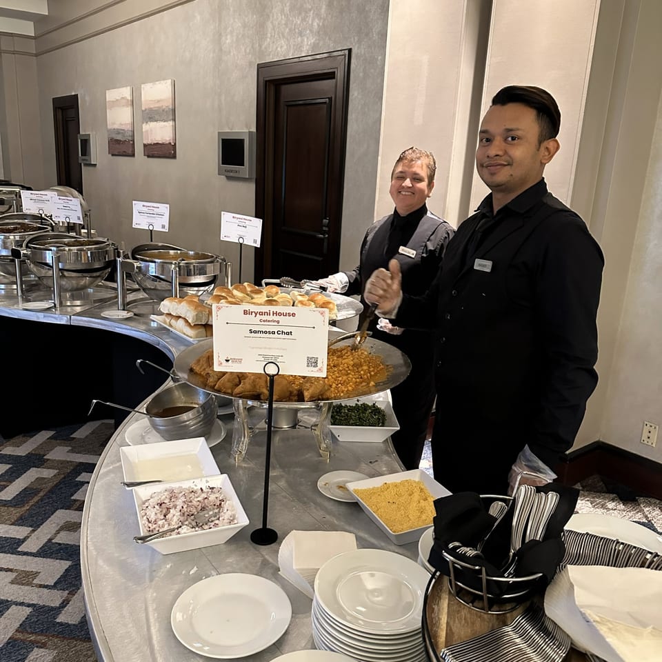 Catering team beside a buffet station