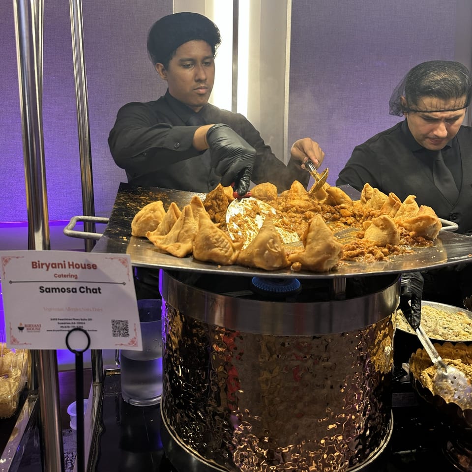 Catering team preparing hot samosa chaat