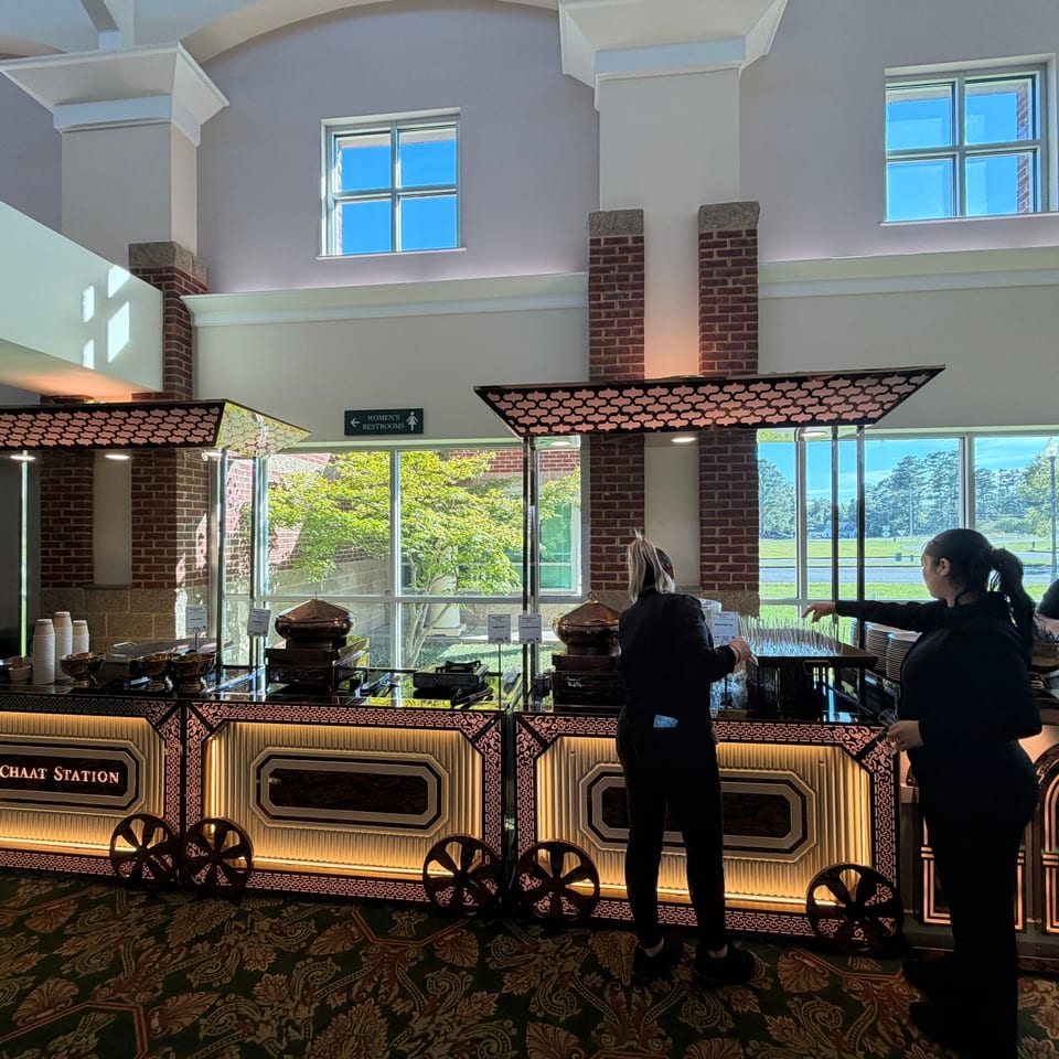 Catering team preparing an illuminated chaat station