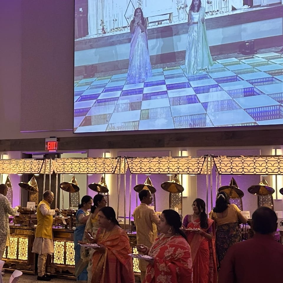 Guests at an illuminated catering buffet